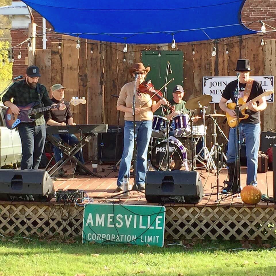 A band plays on stage in Amesville