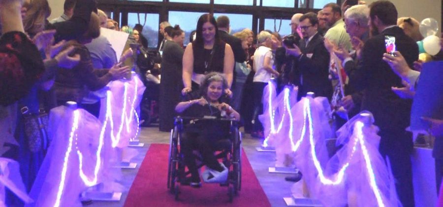People walk down the red carpet during Night to Shine event