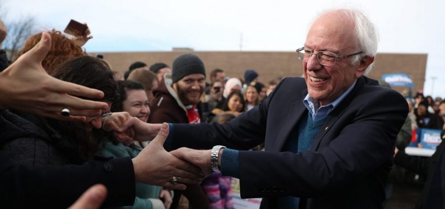 Vermont Sen. Bernie Sanders greets people at a campaign field office in Cedar Rapids, Iowa. Sanders is the slight favorite to win the caucuses, and he hopes it vaults him to the Democratic nomination.