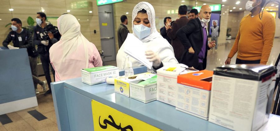 Employees of the Egyptian Quarantine Authority prepare to scan the body temperature of incoming travelers at Cairo International Airport.