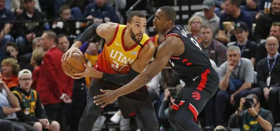Toronto Raptors center Serge Ibaka (9) guards against Utah Jazz center Rudy Gobert (27) in the first half during an NBA basketball game Monday, March 9, 2020, in Salt Lake City.