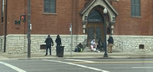 People gather outside Holy Family Church in Columbus, which does outreach to the homeless in Franklin County.
