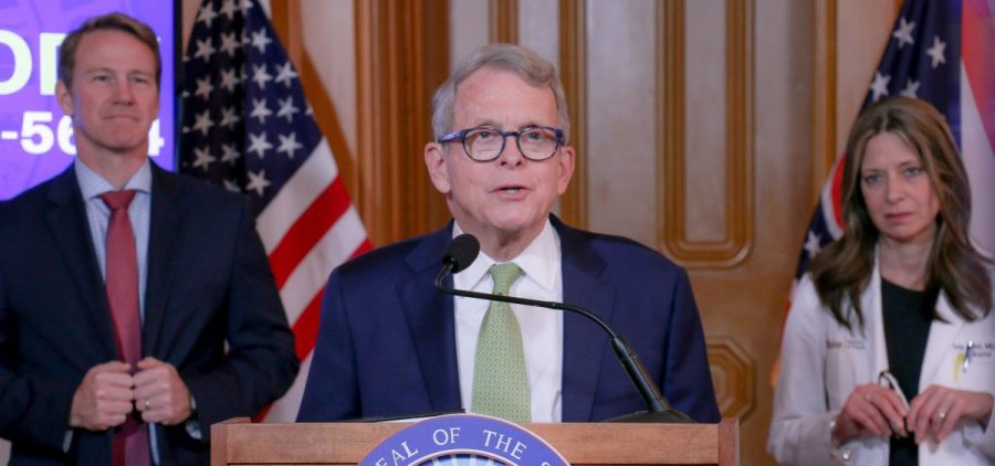 Gov. Mike DeWine speaks at his daily coronavirus press conference on March 20. Behind him are Lt. Gov. Jon Husted and Ohio Department of Health Director Dr. Amy Acton.