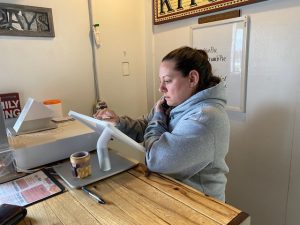 Ray's Harvest House owner Rachel Cotterill take a to-go order. The only business permitted under the governor's closure order