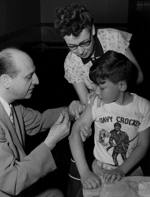 Boy receiving polio vaccine.