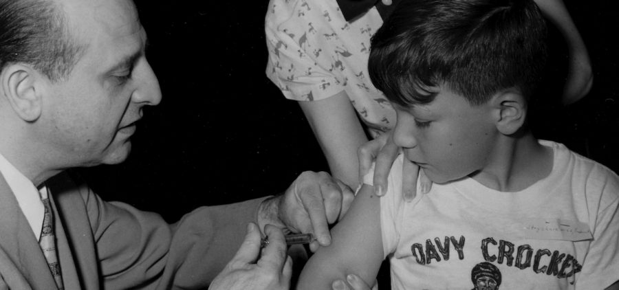 young boy receiving a polio vaccine injection in his arm