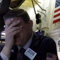 A trader reacts on the floor of the New York Stock Exchange on Monday. Major U.S. stock indexes plunged 7% before trading was temporarily halted.