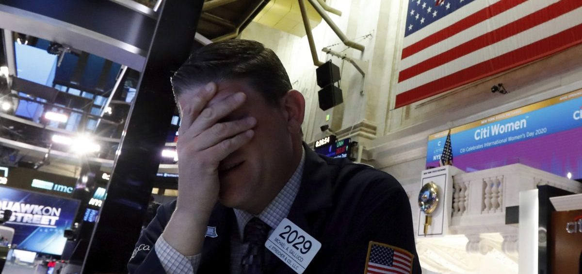 A trader reacts on the floor of the New York Stock Exchange on Monday. Major U.S. stock indexes plunged 7% before trading was temporarily halted.
