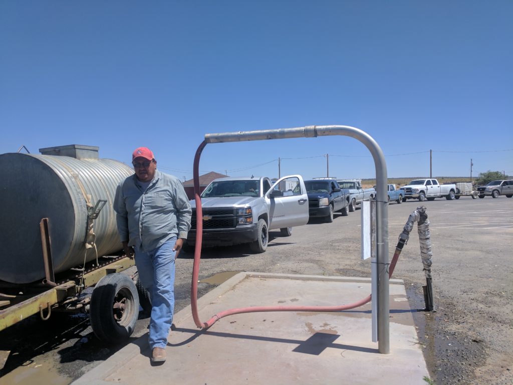 Residents of Black Mesa, AZ, wait to fill water tanks.