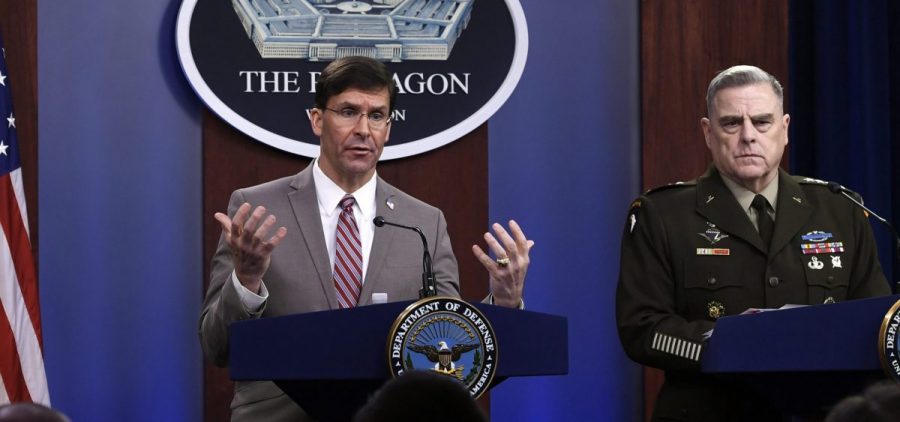 Defense Secretary Mark Esper (left) speaks as Chairman of the Joint Chiefs of Staff Army Gen. Mark Milley listens during a briefing at the Pentagon on Monday.