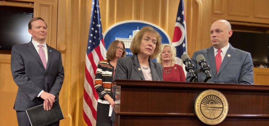 Reps. Gayle Manning (R-North Ridgeville, front left) and Jeffrey Crossman (D-Parma) talk about their bill, as Mark Hill from the Ohio Education Association, Melissa Cropper from the Ohio Federation of Teachers and Rep. Lisa Sobieski (D-Toledo) look on.