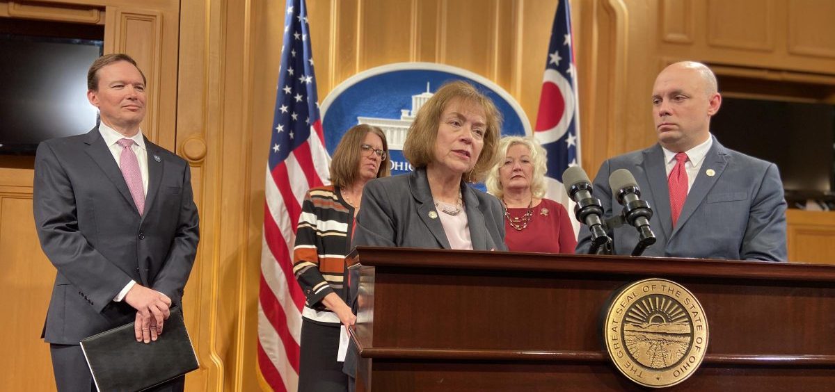 Reps. Gayle Manning (R-North Ridgeville, front left) and Jeffrey Crossman (D-Parma) talk about their bill, as Mark Hill from the Ohio Education Association, Melissa Cropper from the Ohio Federation of Teachers and Rep. Lisa Sobieski (D-Toledo) look on.