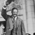 Theodore Roosevelt waves to a crowd.
