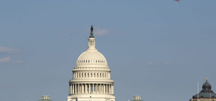 The U.S. Capitol is viewed as a kite flies at the National Mall in Washington earlier this month. Both the House and Senate delayed their return to Washington and leaders are now saying Congress is not expected to return before May 4.