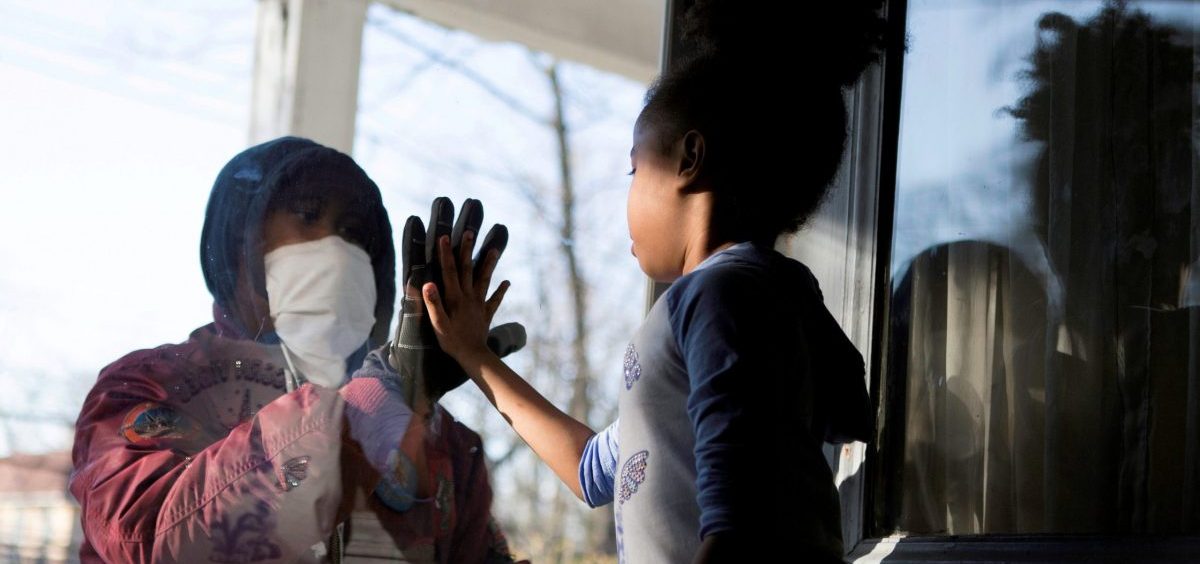 Countries under coronavirus lockdowns should only ease those restrictions if they can control new infections and trace contacts, the World Health Organization says. Here, Hashim, a health care worker, recently greeted his daughter through a glass door as they maintained social distance due to the COVID-19 outbreak in New Rochelle, N.Y.