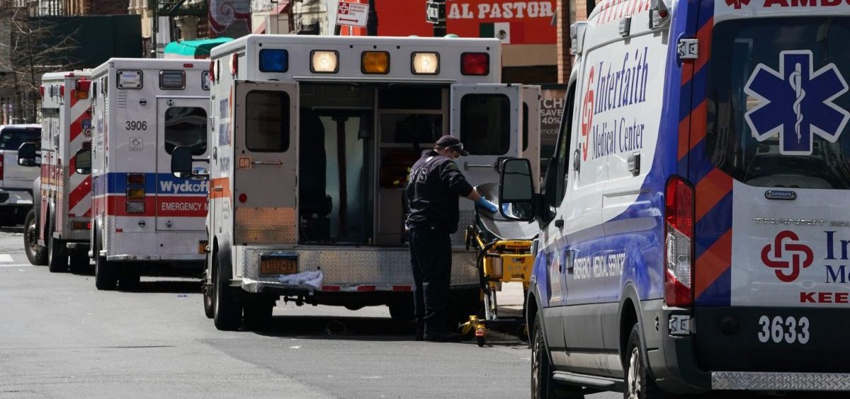 Ambulances are parked outside of Wyckoff Hospital in the Brooklyn, N.Y., on April 4. A study published by the CDC finds that people in the United States under the age of 18 are far less likely to fall ill with COVID-19 or require intensive care, compared with older Americans.
