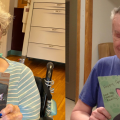Two residents of a nursing home hold up cards they received from a community mail program