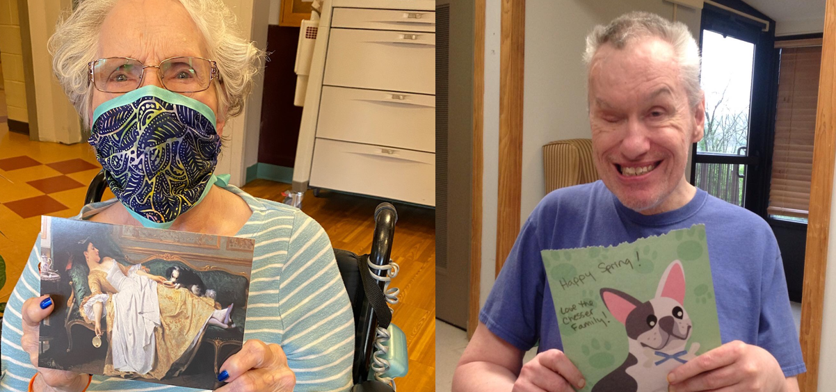 Two residents of a nursing home hold up cards they received from a community mail program