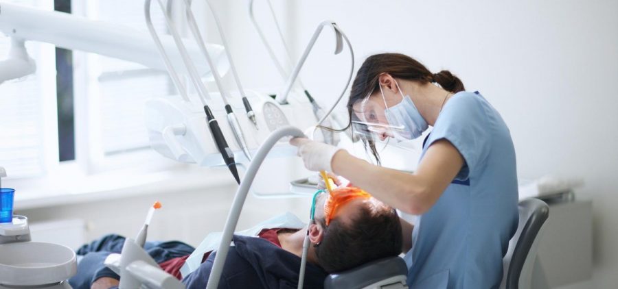 A dental hygienist cleans teeth