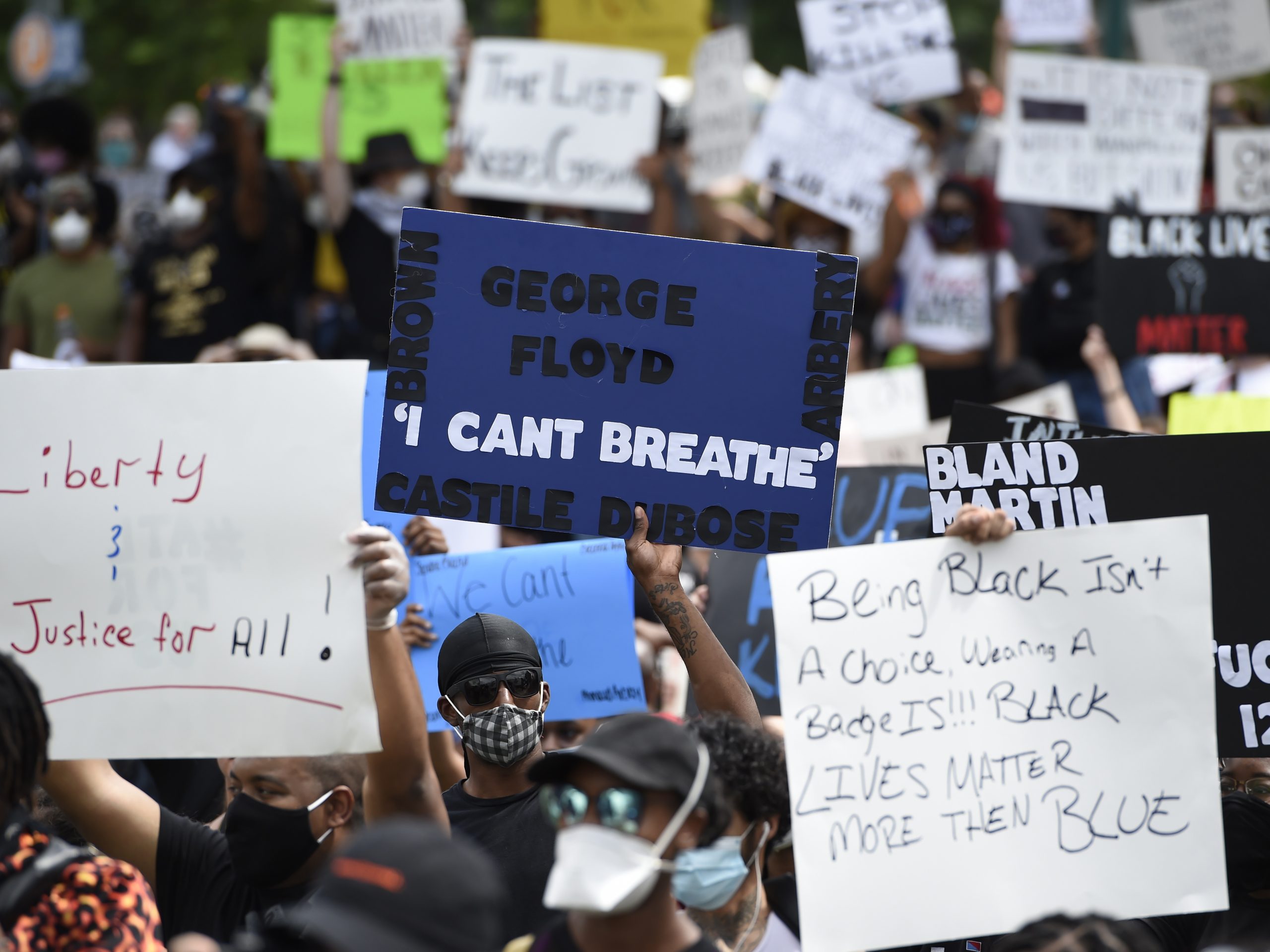 Demonstrators protest Friday in Centennial Olympic Park in Atlanta. Protests were organized in cities around the United States following the death of George Floyd during an arrest in Minneapolis. Former police officer Derek Chauvin was charged Friday with third-degree murder and manslaughter in the incident.