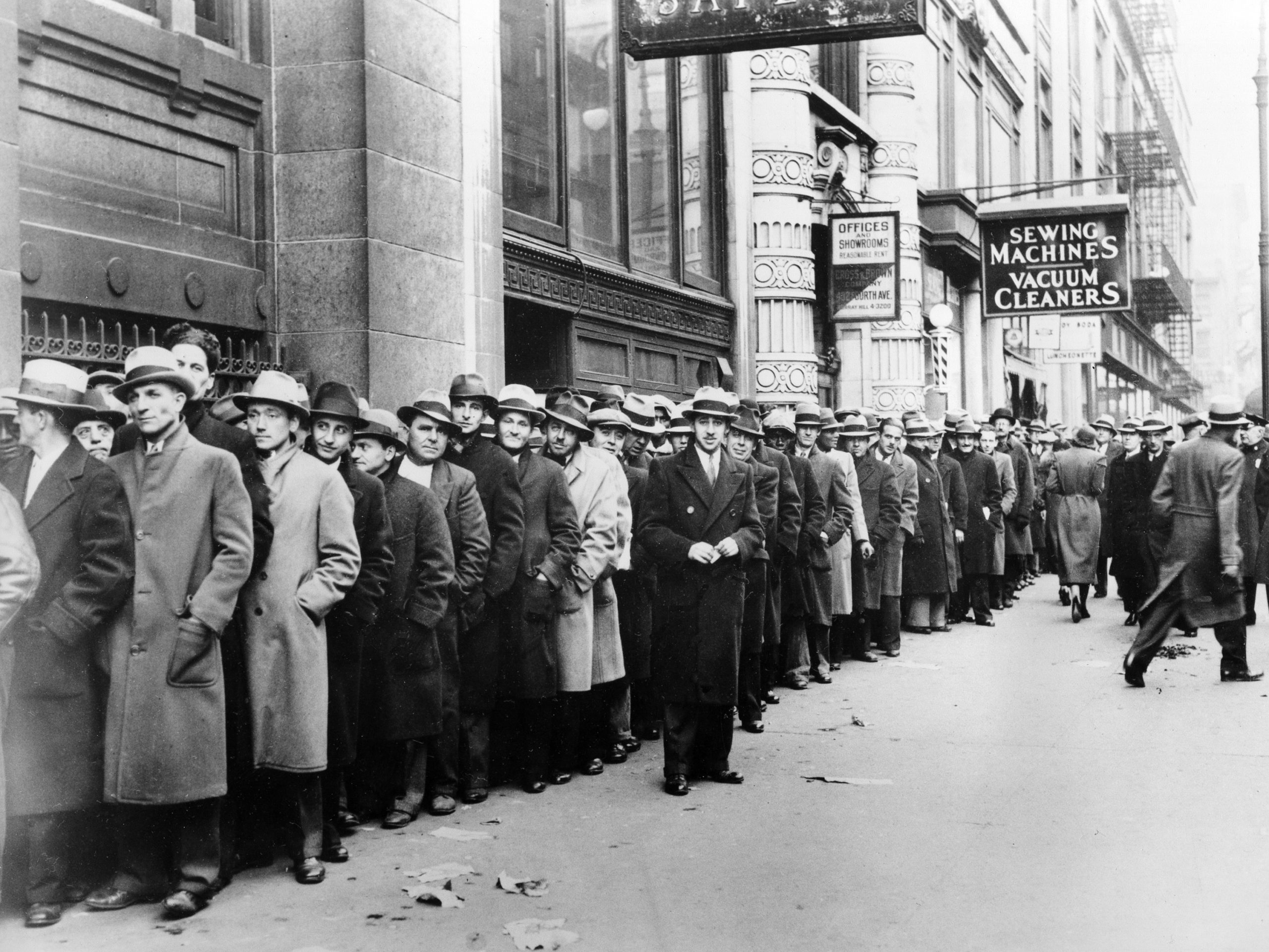 Unemployed people wait outside the state Labor Bureau in New York City in 1933. The current economic crisis has drawn comparisons to the Great Depression, but experts say this downturn should be shorter.