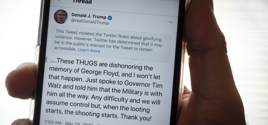 President Trump's Twitter page is displayed on a mobile phone. The social media company flagged one of his tweets about Minneapolis as "glorifying violence" and hid it from public view unless a user clicks on it.