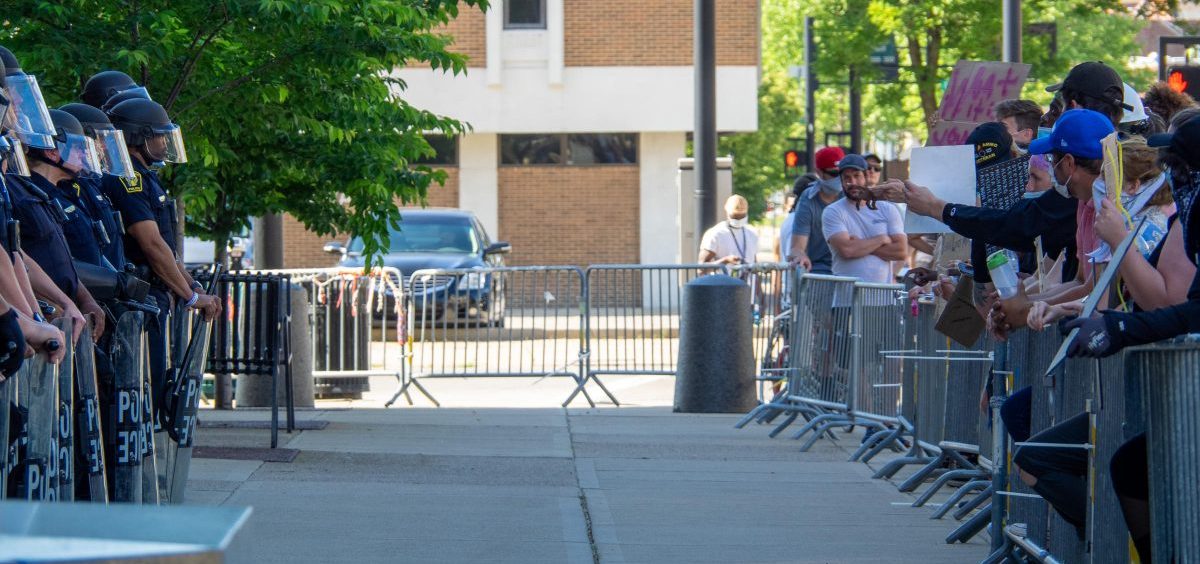 Cincinnati Police Department officers in full riot gear stand across the sidewalk and barricade from protestors as demonstrators continue to rally and protest the murder of George Floyd, Tuesday, June 2, 2020, in Cincinnati.