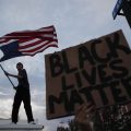 A man waves an upside-down American flag during a protest in Las Vegas following the death of George Floyd, a black man who died after a white Minneapolis police officer knelt on his neck.