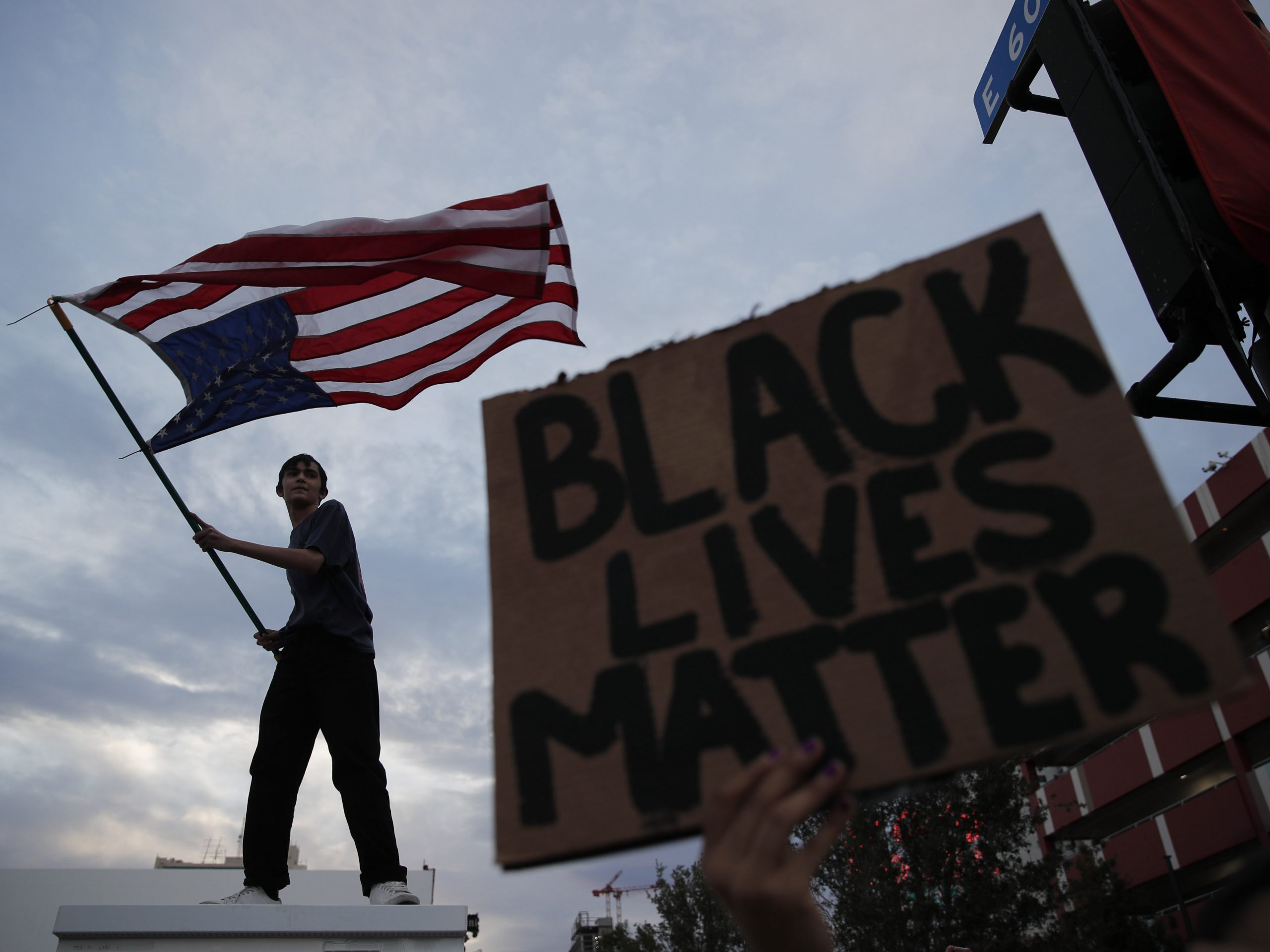 A man waves an upside-down American flag during a protest in Las Vegas following the death of George Floyd, a black man who died after a white Minneapolis police officer knelt on his neck.