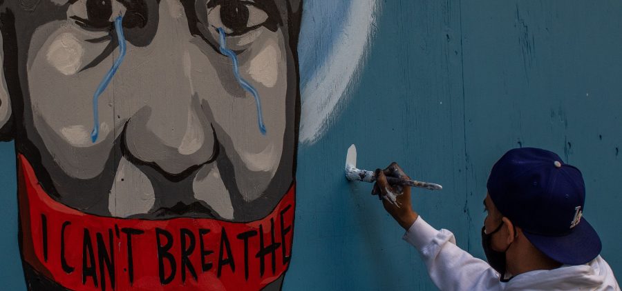 The artist Celos paints a mural in downtown Los Angeles on May 30, 2020 in protest against the killing of George Floyd by police in Minneapolis.