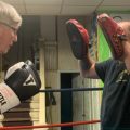 Sam Jones, left, demonstrates some boxing stances and combinations with Rob Robinson at Sam's Gym in Glouster, Ohio, on Wednesday, June 10, 2020.