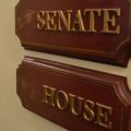 A sign in the Statehouse shows the Senate and the House directions