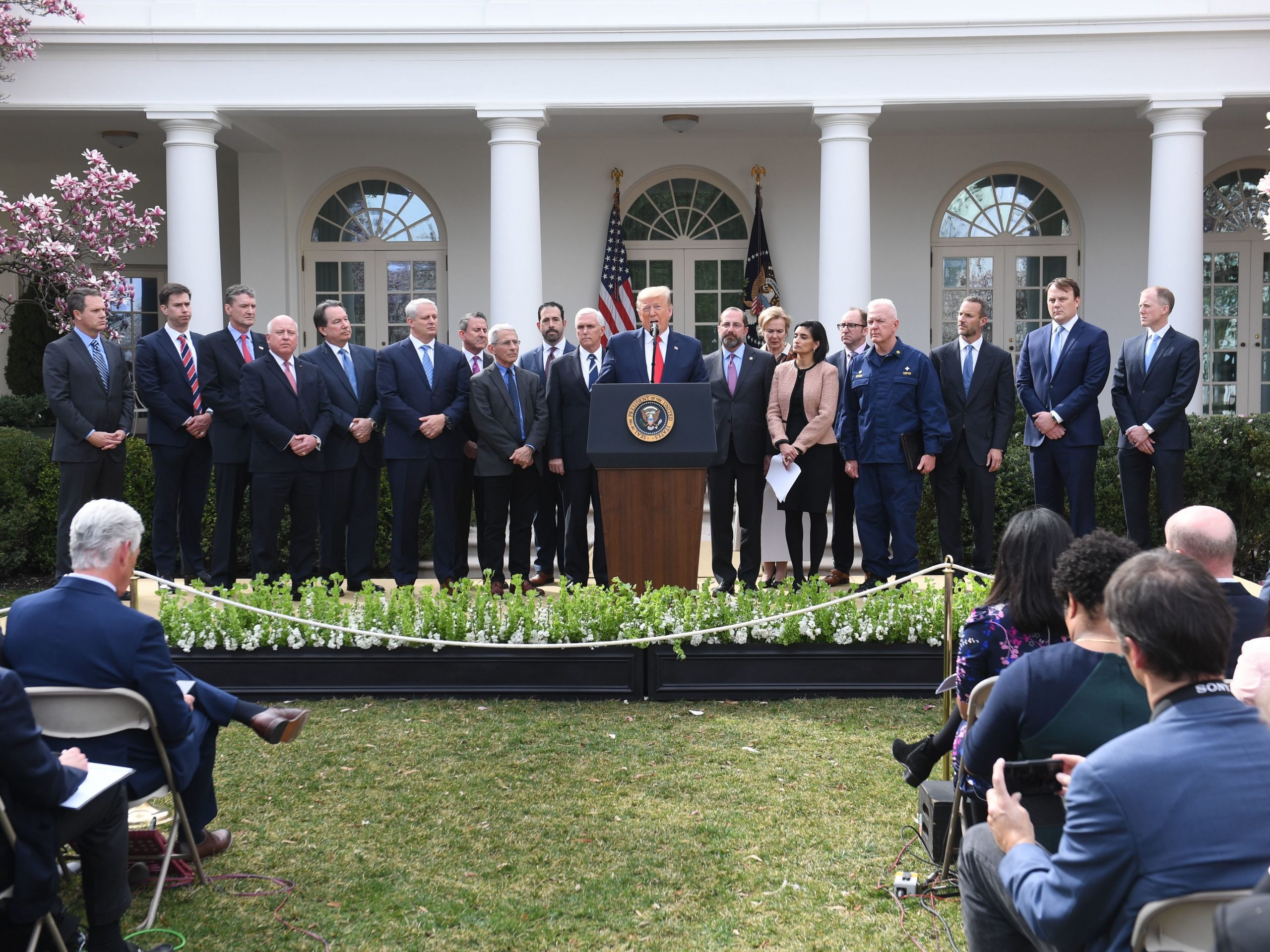 Surrounded by some of the members of the White House Coronavirus Task Force, President Donald Trump speaks at a press conference on COVID-19 in the Rose Garden of the White House on March 13. Of the 27 task force members, two are women, standing to Trump's left: Dr. Deborah Birx and Seema Verna (holding the sheath of papers).