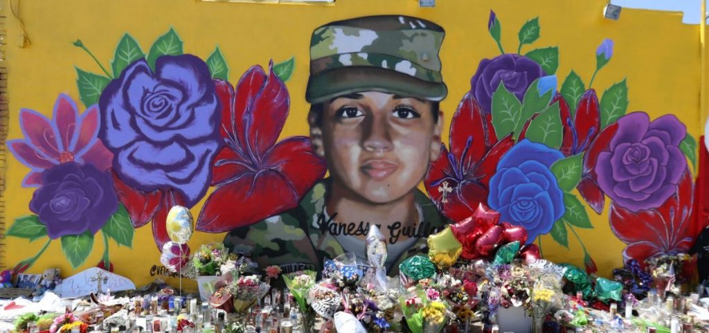 Offerings sit in front of a mural of slain Army Spc. Vanessa Guillen painted on a wall in the south side of Fort Worth, Texas, Saturday, July 11, 2020. U.S. Army officials say they will begin an independent review of the command climate at Fort Hood, examining claims and historical data of discrimination, harassment and assault, following calls for a more thorough investigation into the killing of the soldier from the Texas base.