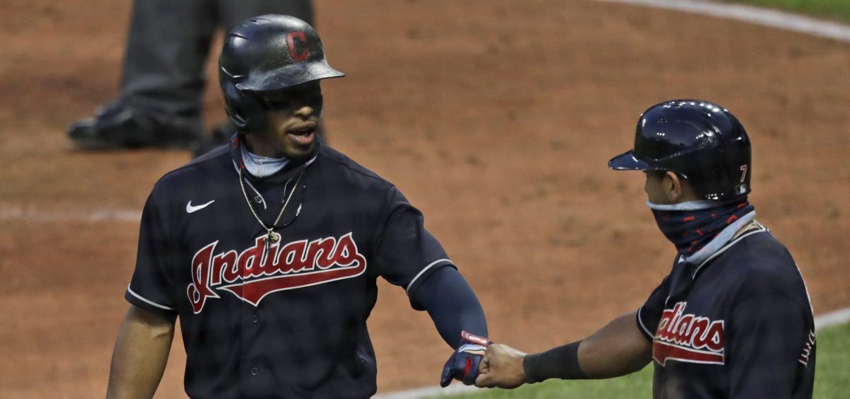 Cleveland Indians' Francisco Lindor, left, is congratulated by Cesar Hernandez after hitting a three-run home run in the fifth inning during a preseason baseball game against the Pittsburgh Pirates, Monday, July 20, 2020, in Cleveland.