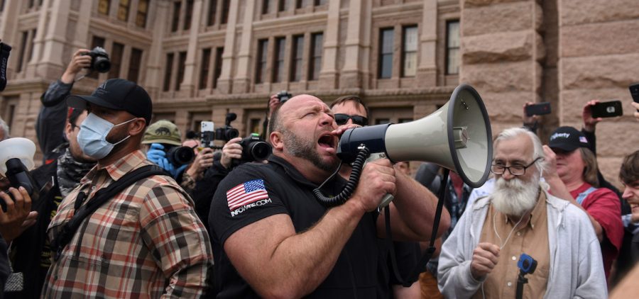 Alex Jones screams into a megaphone as protesters against the state's extended stay-at-home order to help slow the spread of the coronavirus disease (COVID-19) demonstrate at the Capitol building in Austin, Texas, U.S., April 18, 2020. REUTERS/Callaghan O'Hare - RC267G9OA1E0