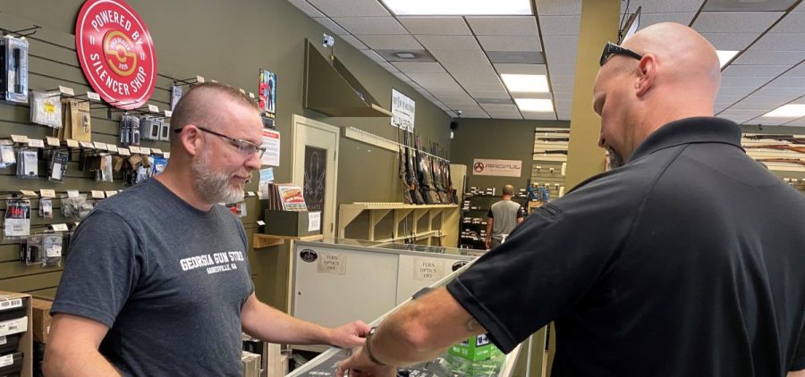 "Most of it is is new gun owners," says Michael Weeks (left), a gun store owner in Gainesville, Ga. By one estimate, Americans have bought nearly 3 million more guns than usual since March.