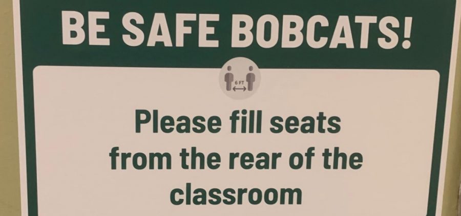 A sign inside one of Ohio University's academic buildings encouraging students to fill seats from the back of the room