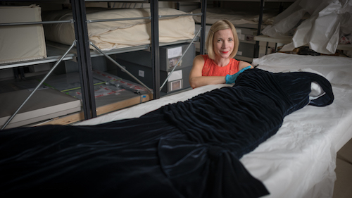 Lucy Worsley with the velvet dress worn by Princess Diana when she danced with John Travolta
