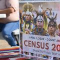 A sign promoting participation in the 2020 census is displayed as Selena Rides Horse enters information into a phone for a member of the Crow Indian Tribe in Lodge Grass, Mont., in August.