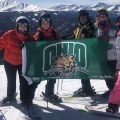Beagle and family holding Ohio University flag