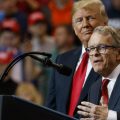 President Donald Trump stands with gubernatorial candidate Mike DeWine as he speaks during a rally, at the IX Center, in Cleveland, Monday, Nov. 5, 2018.