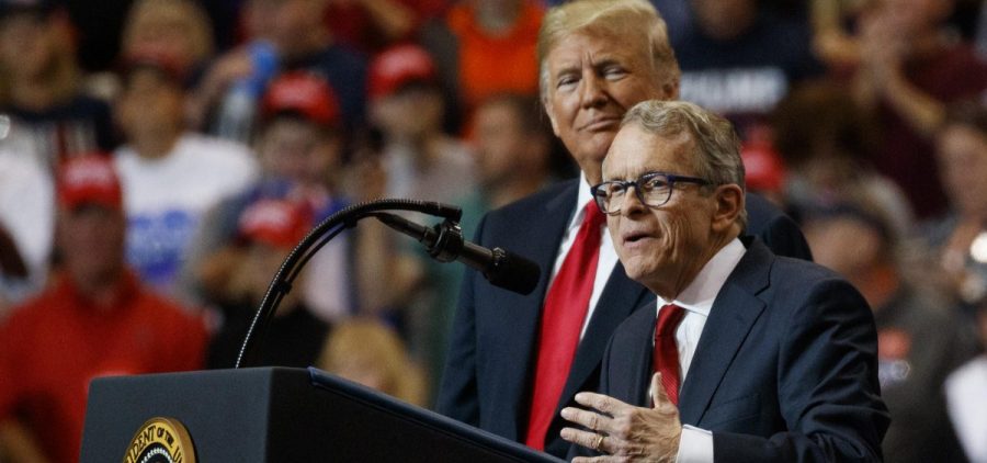 President Donald Trump stands with gubernatorial candidate Mike DeWine as he speaks during a rally, at the IX Center, in Cleveland, Monday, Nov. 5, 2018.