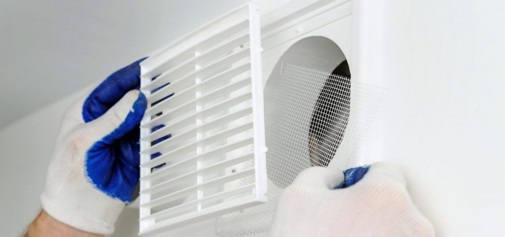 An installer fixes an air vent