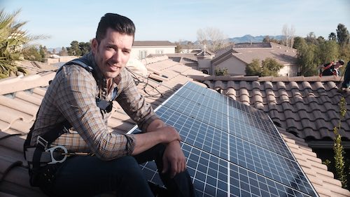 "Power Trip" director Jonathan Scott takes a break from installing solar panels on a rooftop.