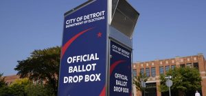 Voters can drop off absentee ballots at a ballot drop box in Detroit instead of using the mail.
