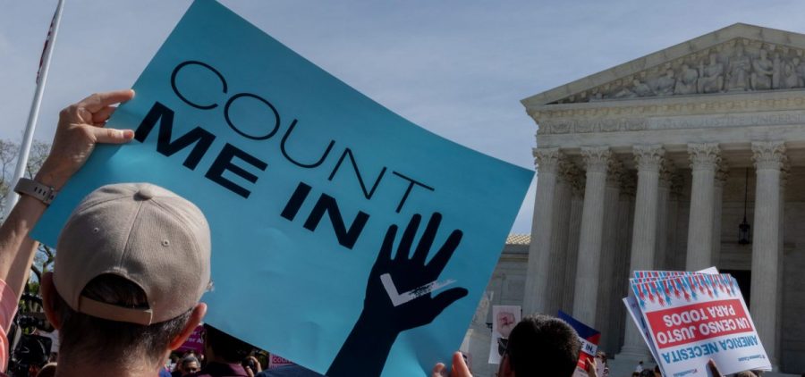 Protesters holding signs about the 2020 census gather outside the Supreme Court in Washington, D.C., in 2019.