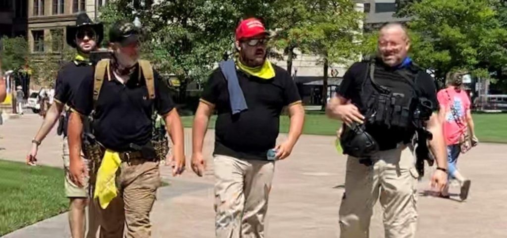 Some demonstrators at an anti-mask rally at the Statehouse in July. Event planners said security would be provided by "militia". Proud Boys are often identified by black collared polo shirts with yellow stripes on the sleeves.