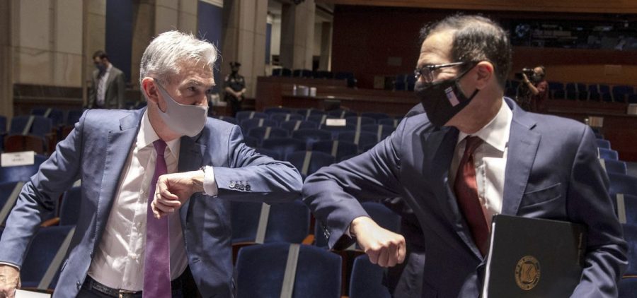 Fed Chairman Jerome Powell and Treasury Secretary Steven Mnuchin bump elbows at the conclusion of their testimony before Congress on June 30, 2020. The Fed and Treasury are engaging in a rare clash over the fate of key pandemic lending programs.