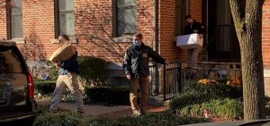 FBI agents carry boxes out of the Columbus home of Public Utilities Commission Chair Sam Randazzo.